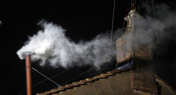 White smoke emerges from the chimney on the roof of the Sistine Chapel, in Saint Peter's Square at the Vatican on March 13. The white smoke indicates that the new pope has been elected. | AP Photo